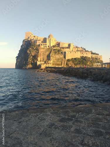 Ischia, Italy with Aragonese Castle in the Mediterranean at dusk. photo