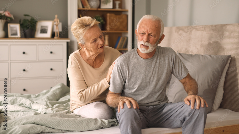 © Stockphotodirectors - Elderly woman comforting her ill husband in bedroom