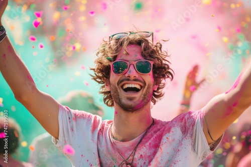 Man reveling in the exuberance of a vibrant color festival, arms wide open.