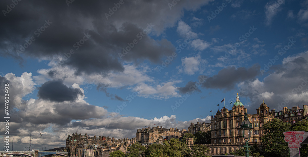 clouds over the city and blue sky with historic architectural buildings in edinburgh