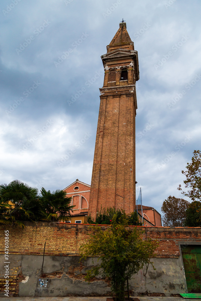 Famous leaning bell tower Campanile Pendente of Saint Martin Bishop Church on Burano island, Venice, Italy