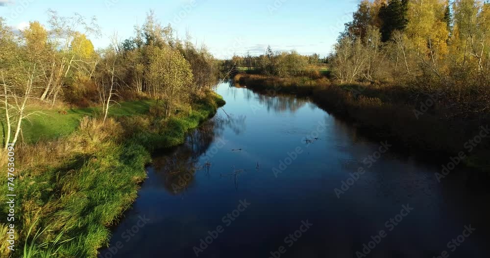 Moving over a river on a late autumn evening in rural Estonia, Northern Europe