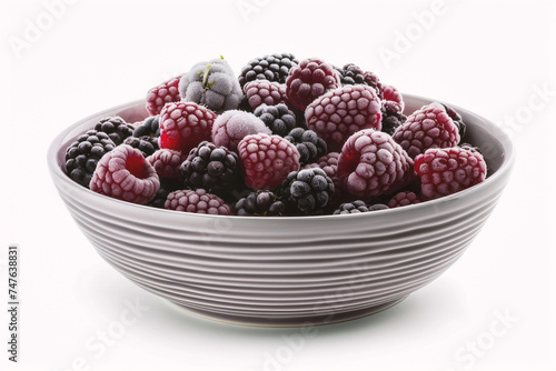 Frozen blackberries and raspberries in a bowl isolated on white background