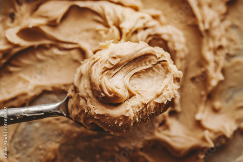 Creamy peanut butter on a spoon, close-up.