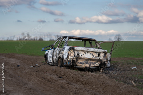 A burned out car. Burnt car in the field. Car fire, vehicle fire due to short circuit. Stolen car intentional arson. One vehicle was damaged in the fire. © Varga_photography
