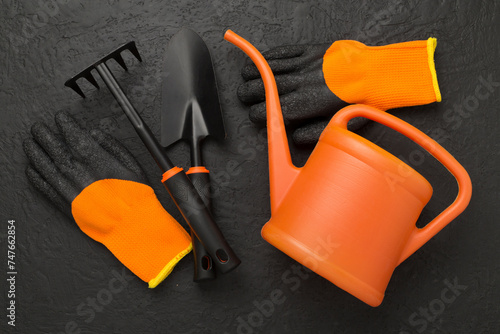 Orange gardening tools on conctere background, top view photo