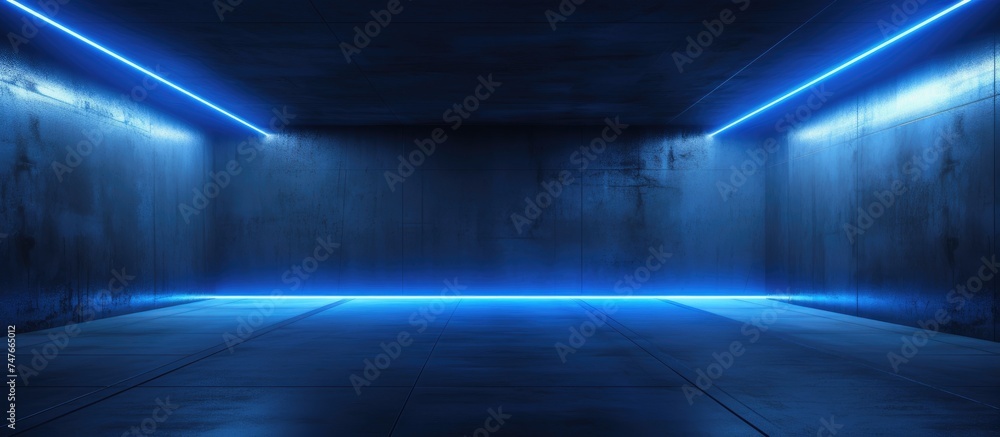 A dark room with a concrete floor is illuminated by blue lights, creating a stark and modern aesthetic. The glossy blue lines add a hint of color to the otherwise minimalistic space.