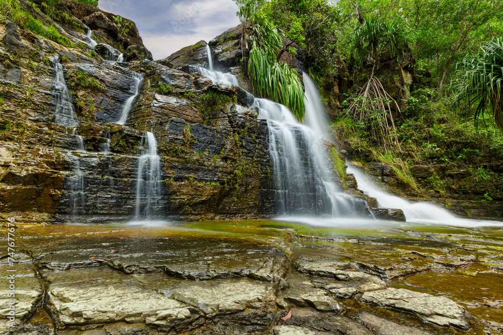 Obraz premium A low perspective of the upper Tarzan Falls on the tropical island of Guam, a US territory.