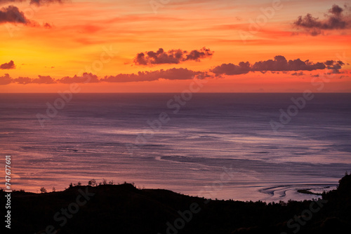 Sunset over Sella Bay shoreline with reflecting colors on the ocean on the island of Guam