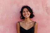 Portrait of a Young Asian Woman Smiling Against a Soft Pink Textured Background, Embodying Carefree Joy and Beauty