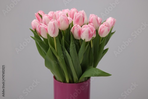 Fototapeta Naklejka Na Ścianę i Meble -  Beautiful bouquet of fresh pink tulips on light grey background