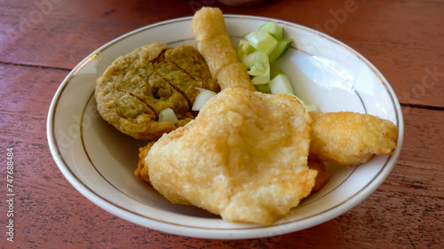 Pempek or Empek-empek is popular savory fishcake from Palembang, South Sumatra, Indonesia. Served on white plate. photo