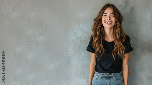 Brunette young woman wear black t-shirt smile isolated on grey background