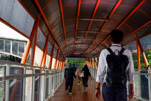 Rows of People walking on the Sky Walk which is integrated with Jakarta's public transportation