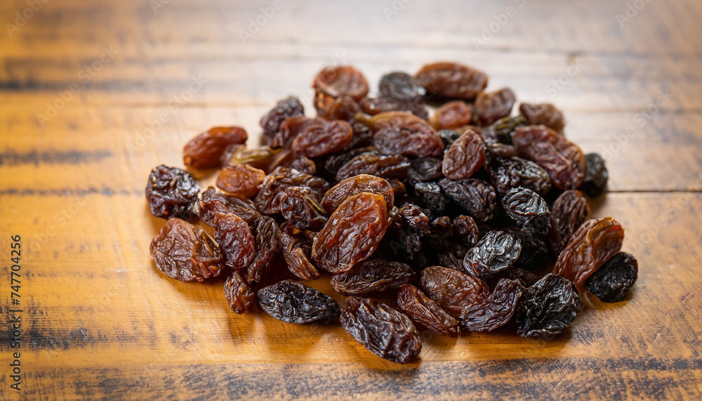 raisins on wooden table background, selective focus (detailed close-up shot) raisins on wooden table background, selective focus (detailed close-up shot)