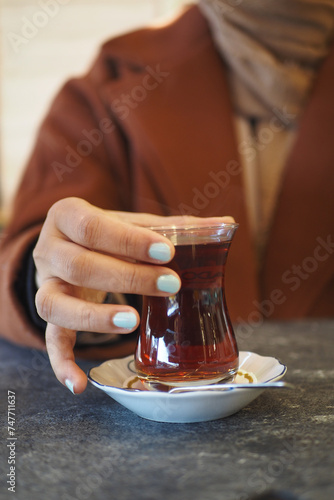 women holding aTraditional turkish tea photo