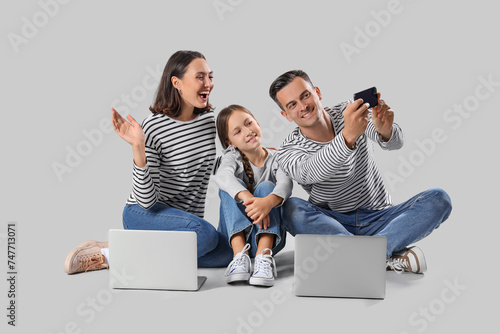 Happy family with gadgets t...