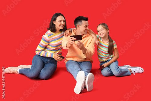 Happy family sitting on flo...