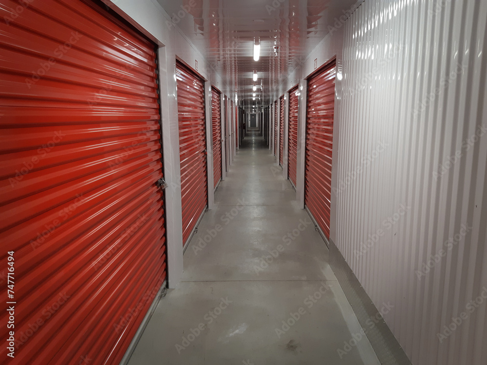 View down the long hallway of a typical storage facility with lockers.  