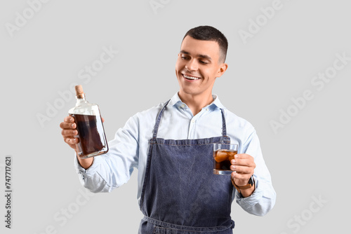 Young male bartender with b...