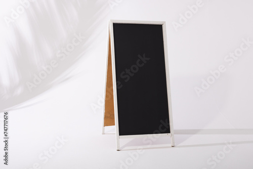 A blank sandwich board sign stands ready for customization or advertising, with copy space