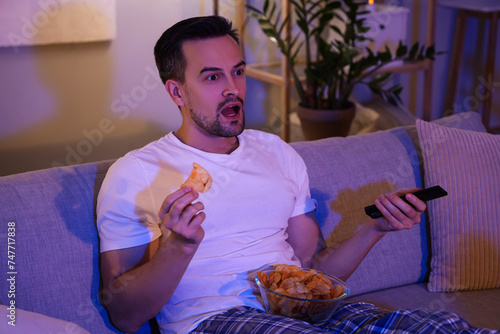Shocked man with potato chi...