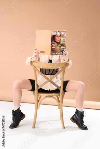 Young woman reading fashion...