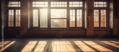 The suns rays stream through the windows, casting bright light across the empty room. The warmth and brightness fill the space, creating a sense of illumination and openness.