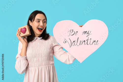 Excited young woman holding...