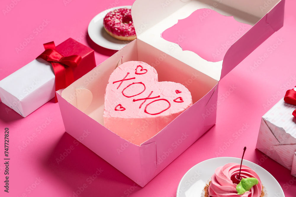 Heart-shaped bento cake with gift boxes, cupcake and donut on pink background. Valentine's Day celebration Heart-shaped bento cake with gift boxes, cupcake and donut on pink background. Valentine's Day celebration