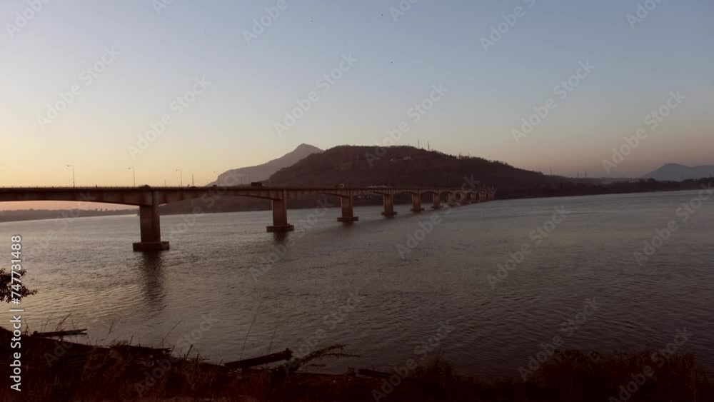 The grand Friendship Bridge spans the Mekong River, presenting a picturesque vista. As a crucial passage for daily travelers, it symbolizes both connectivity and the allure of its scenic beauty. The grand Friendship Bridge spans the Mekong River, presenting a picturesque vista. As a crucial passage for daily travelers, it symbolizes both connectivity and the allure of its scenic beauty.