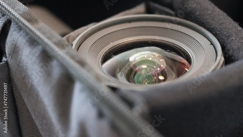 Close up shot of a Tokina 11-16mm f2.8 lens in a camera bag. Shot at 60FPS, slowed down to 24FPS. Shot on canon 80D with 50mm f1.8. STM. photo