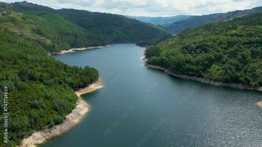 Dam aerial shot in northern Portugal, Salamonde, Montalegre, Portugal, aerial shot on a sunny day geres national park, calm lake Dam aerial shot in northern Portugal, Salamonde, Montalegre, Portugal, aerial shot on a sunny day geres national park, calm lake
