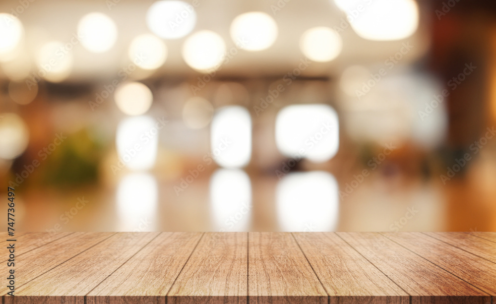 Empty wooden table top with lights bokeh on blur restaurant background.