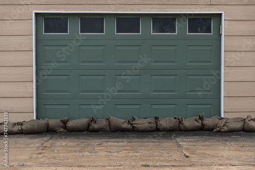 After the storm - sandbags against the door to keep the garage dry from a natural disaster weather bomb.