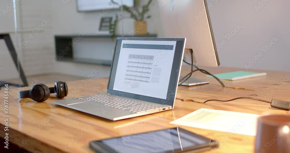 A modern business laptop open on a desk at an office, with copy space A modern business laptop open on a desk at an office, with copy space