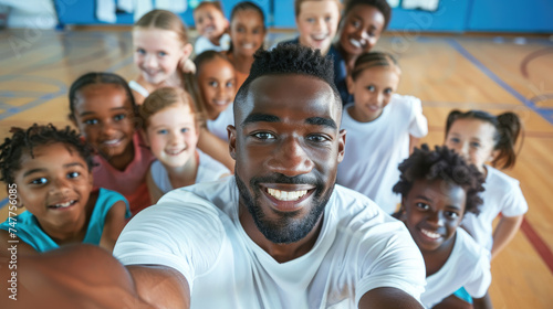 Happy PE teacher and school kids taking selfie during exercise class