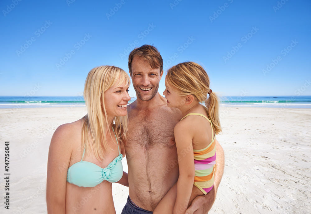 Love, hug and happy family at a beach with support, security and bonding in swimwear in nature. Travel, freedom and kid with parents at the ocean for swimming, adventure and summer fun in Maldives