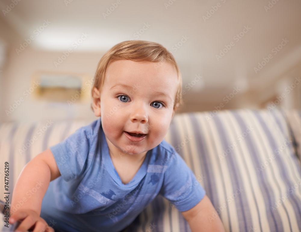Playing, crawl and portrait of baby in sofa or home for fun, growth or learning alone in living room. Energy, boy or face of a curious male kid on couch for child development or wellness in a house