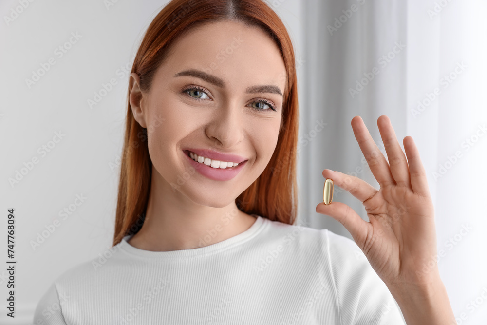 Beautiful young woman with vitamin pill at home Beautiful young woman with vitamin pill at home