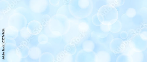 Abstract circle bokeh wallpaper. Smooth soft blue blur effect background. Shiny blurry light sparkles texture. Seasonal backdrop for Christmas, New Year or birthday card, poster, banner. Vector photo