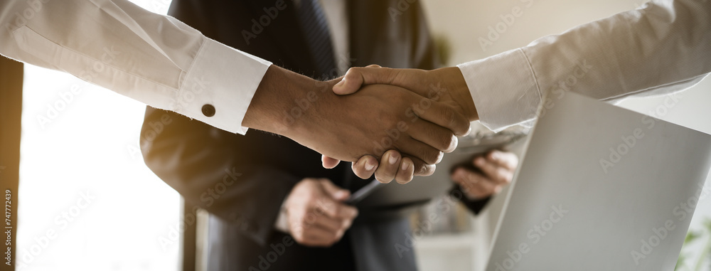 Banker and client shaking hands after business loan grant.