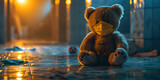 Teddy bear toy sitting on the street floor in rain.