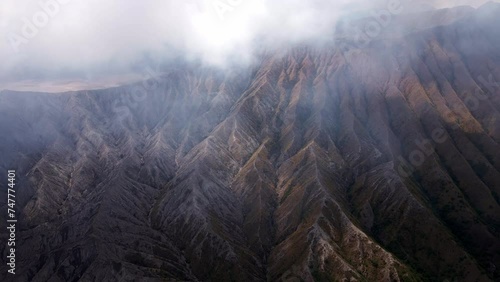 the shivering majesty of Mount Bromo's active volcano, a dangerous and myterious mountain in East Java, aerial 4k footage photo
