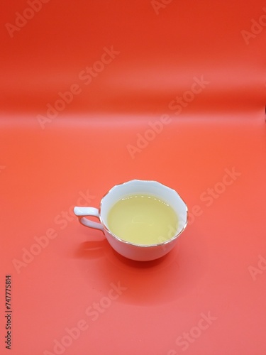 Close-up a cup of tea on red background.