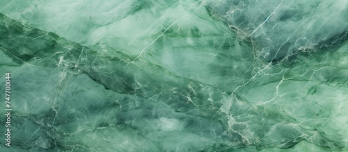 A textured background resembling green marble, ideal for interior design projects or as a decorative element. The pattern mimics the unique veining and swirling characteristic of marble,