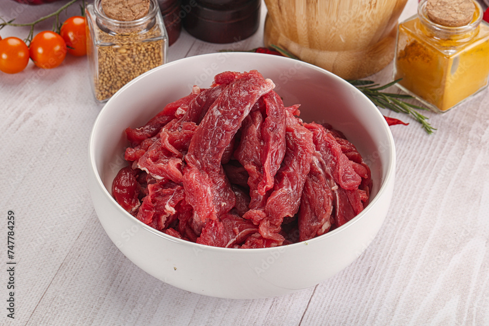 Raw beef meat - sliced strips Raw beef meat - sliced strips