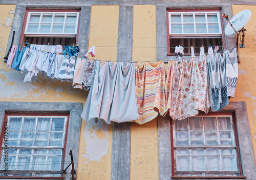 Ropa tendida en una fachada con ventanas photo