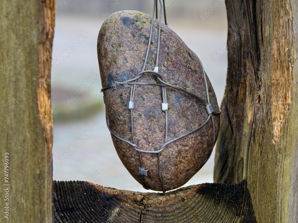 stone suspended on a steel cable. geology