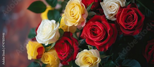 A stunning closeup of a bouquet featuring vibrant red  yellow  and white roses in full bloom  creating a beautiful and colorful display.